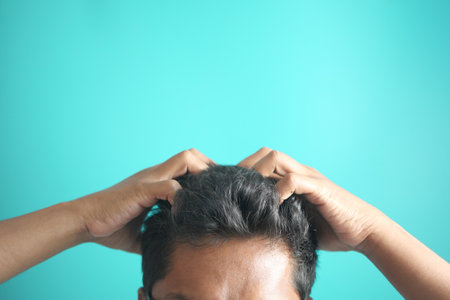 men Scratching Head Against color background .の写真素材