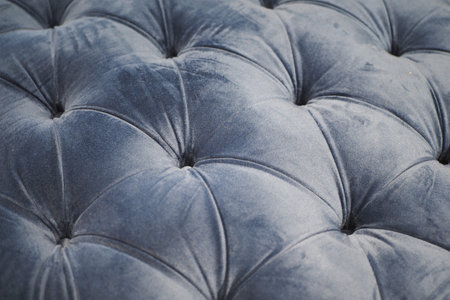 a texture of leather gray sofa with buttons