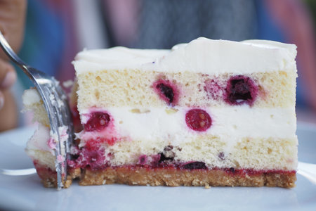 Hand takes with teaspoon fresh baked cake with jamの写真素材