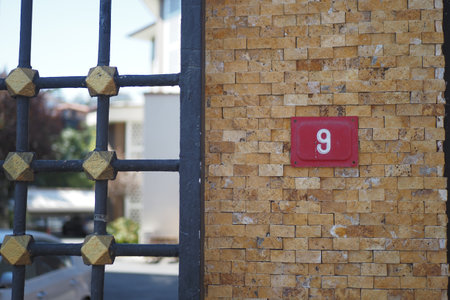 house number six. Decorative lettering on a brick wall.の写真素材