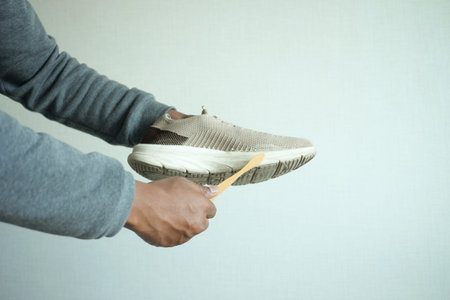 Man washing dirty shoes with a brush,の写真素材