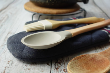 wooden cutlery forks and cooking pan on tableの写真素材