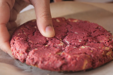 women hand creaking red velvet cookiesの写真素材