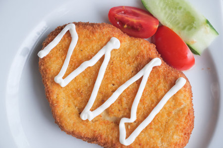 Chicken schnitzel served salad on a plate