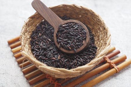 Black Rice Grains in a wooden bowl .の写真素材