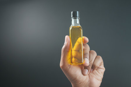 hand holding a bottle of olive oilの写真素材