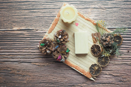 Homemade natural soap bar and dry flower on black background