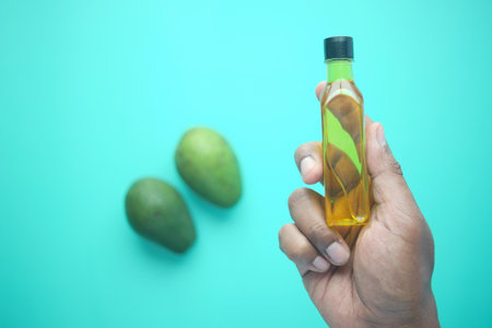 holding a bottle of avocado oilの写真素材