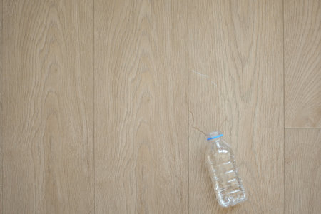 top view of a bottle of water spilled on a floor ,の写真素材