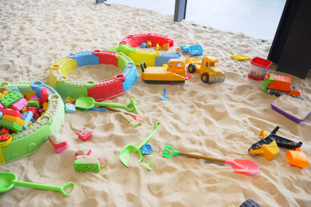 sand and colorful toys in a playground indoors.の写真素材