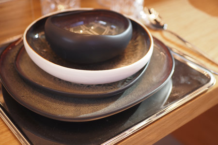 round bowl or ceramic plate on napkin on wooden table.の写真素材