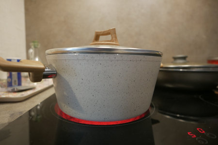 cooking pan on electric stove, electric stove is heated to red.