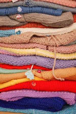 stack of knitted warm sweaters with different knitting patterns.の写真素材