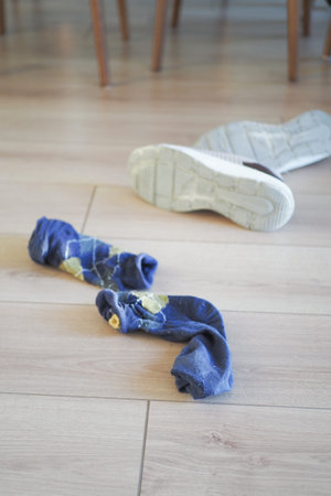 dirty sock and shoe on floorの写真素材