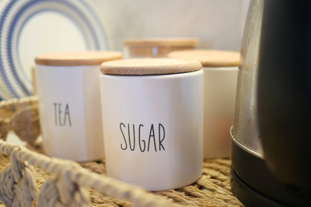 A wicker basket with tea and sugar jars for a charming tea eventの写真素材