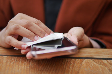 women cleaning mobile phone display for preventing virusの写真素材