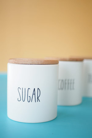 A wicker basket with tea and sugar jars for a charming tea eventの写真素材