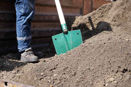 a man digs his spring garden with an old shovel.の写真素材