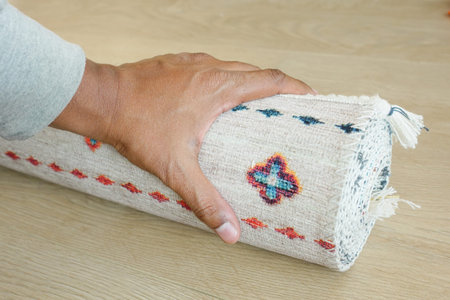 hand rolling out new rug.