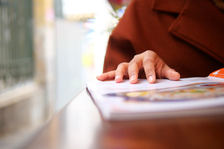women hand reading a food menu at cafe.の写真素材