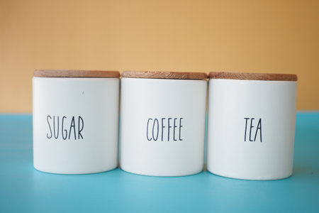 A wicker basket with tea and sugar jars for a charming tea eventの写真素材