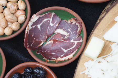 turkish meat pasturma in a bowl served with cheese on table