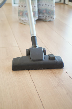 woman cleaning floor dust with vacuum cleaner.の写真素材