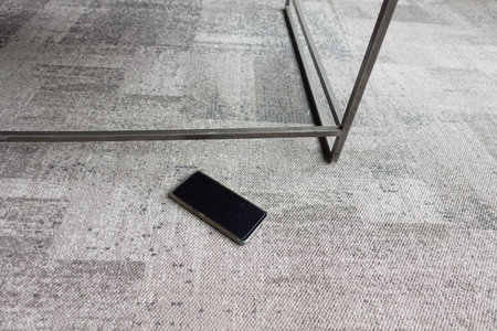 forget smartphone on floor at homeの写真素材
