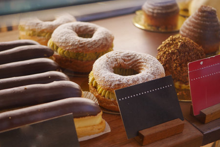 An array of baked goods, including pastries, is showcased in the bakeryの写真素材