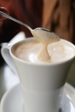 late coffee on cafe table at cafe backgroundの写真素材