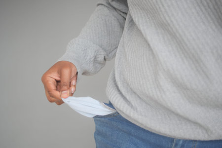 young man shows empty pant pocket with copy space