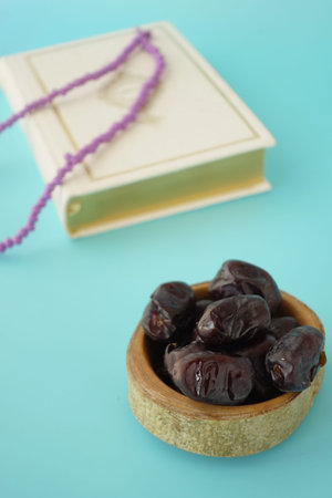 Holy book Quran and rosary on table, close up.