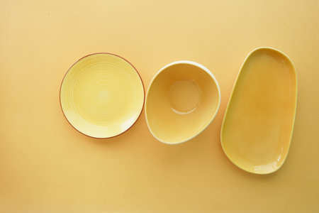 top view of different shape yellow color bowl or ceramic plate