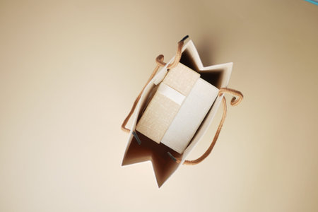Gift or present box with paper packet on orange color background ,