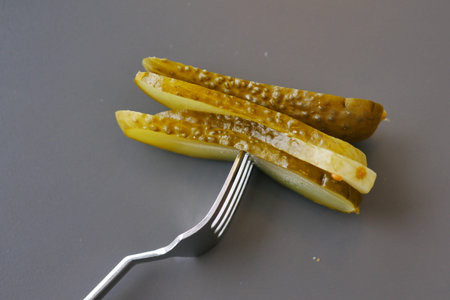 a close up of a pickle on a plate with tomatoes