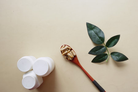 top view of herbal medicine capsule on wooden spoonの写真素材