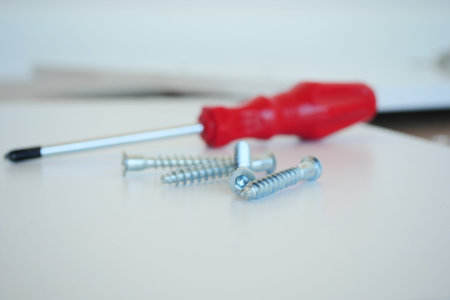 metal screw or bolt and nuts wooden background.