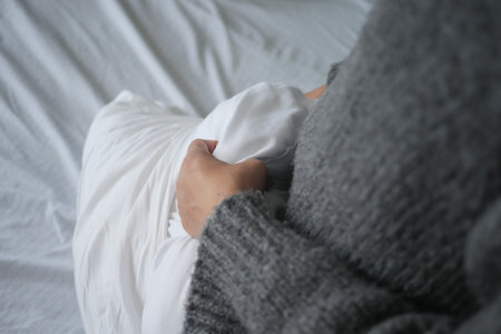 Woman Puts Pillow Into Pillowcase.