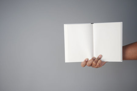 holding a open notepad on gray background