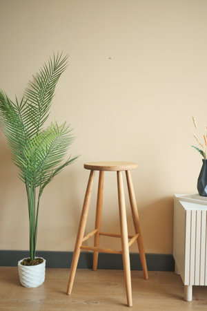 Wooden stool and potted plant complement rooms interior design.の写真素材