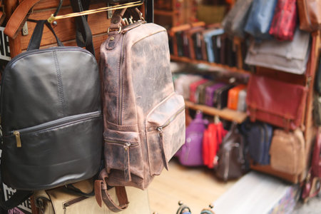Close up of leather handmade bags on a wall for sale .の写真素材