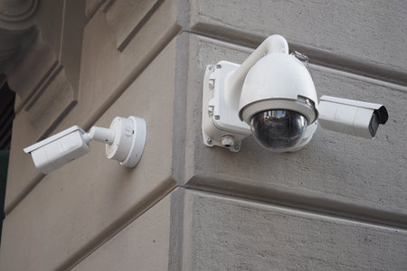 Three CCTV security camera operating on a building outdoor