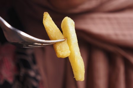 Closeup of fork Pick French Fries