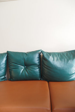 modern leather sofa with pillows at cafe restaurant
