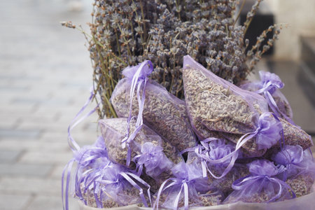 A stack of purple lavender bags fills the basket, creating a beautiful patternの写真素材