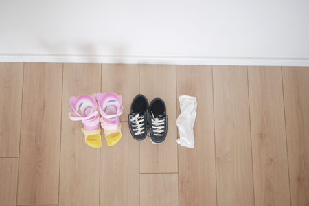 child legs orthosis and shoes on a wooden floor