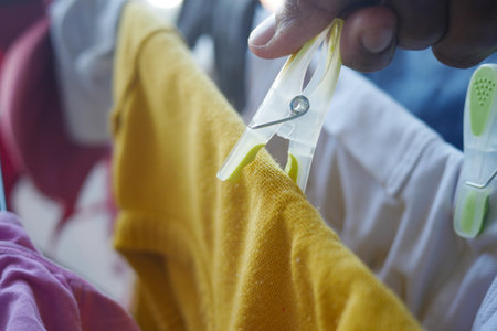 putting a blue clothespins on clothの写真素材