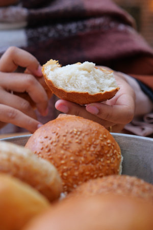 woman hand pick baked bun on table
