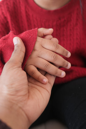 father holding hand of baby child,