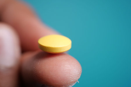 Close up of man hand holding pills with copy space